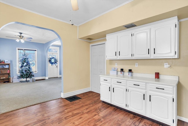 kitchen featuring white cabinetry, dark hardwood / wood-style flooring, and ceiling fan