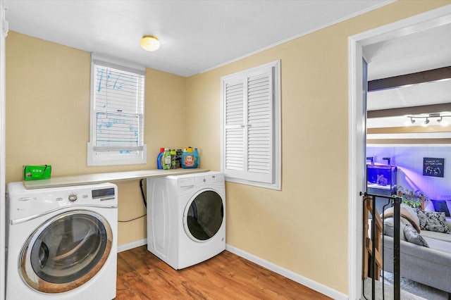 laundry area featuring dark wood-type flooring and independent washer and dryer