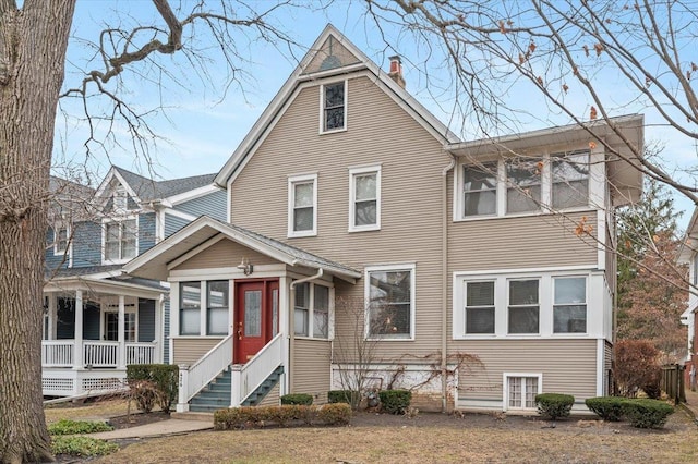 view of front of house featuring entry steps and a chimney