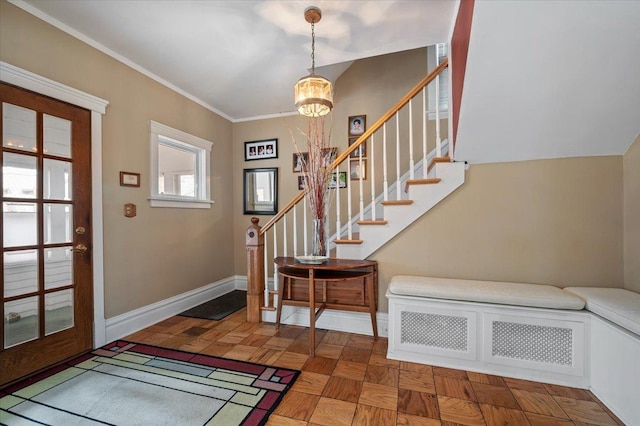 entryway featuring stairway, a notable chandelier, baseboards, and ornamental molding