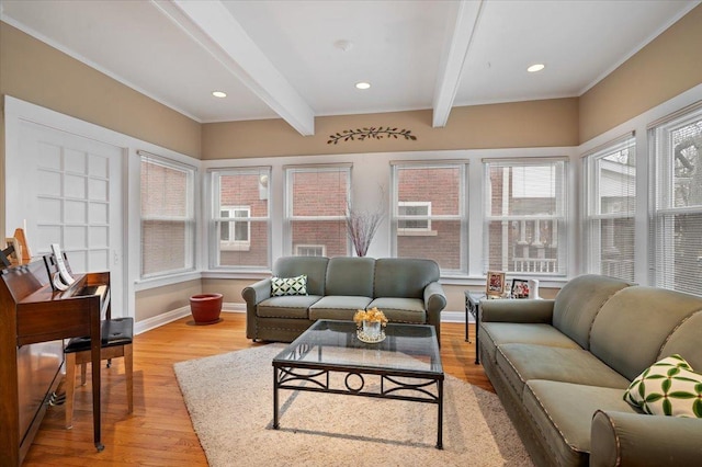 living area with beam ceiling, light wood finished floors, and baseboards