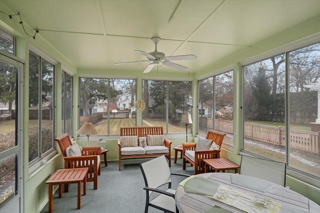 sunroom featuring ceiling fan