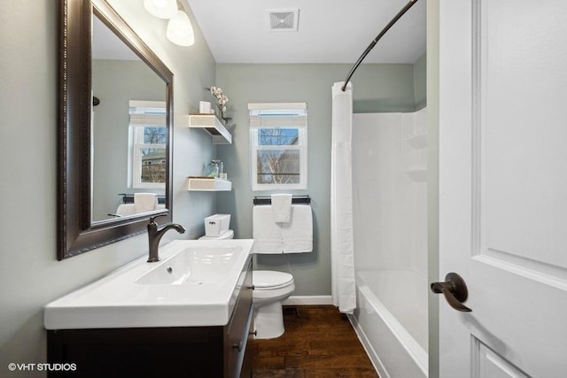 full bathroom with shower / tub combo, hardwood / wood-style floors, vanity, and toilet