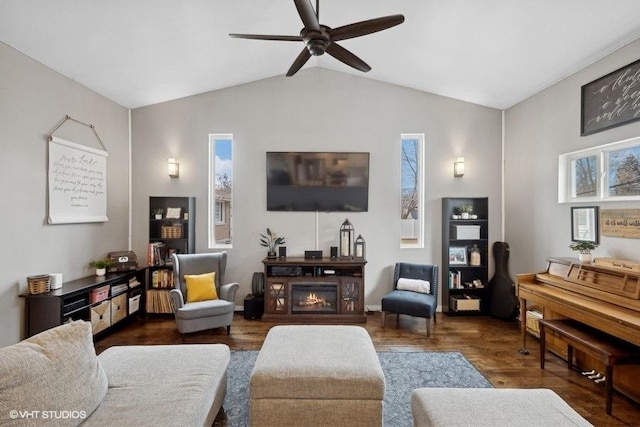 living room with ceiling fan, lofted ceiling, and dark hardwood / wood-style flooring