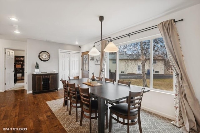 dining area with dark hardwood / wood-style flooring