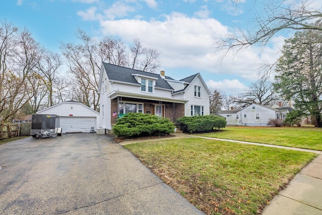 view of front of house with an outbuilding, a garage, and a front lawn