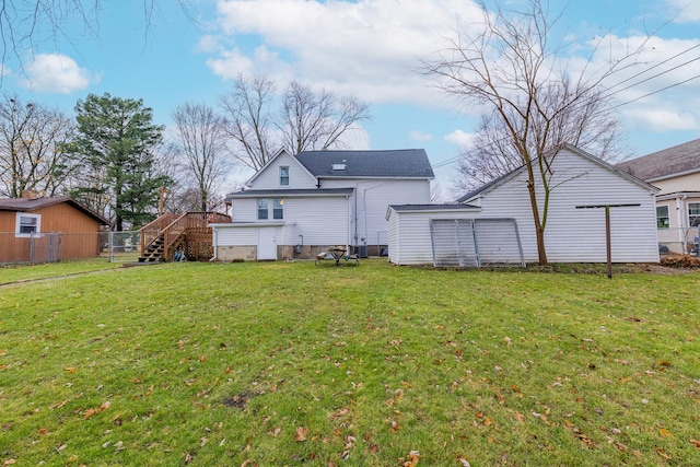 back of property with a wooden deck and a lawn