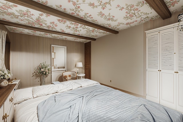 bedroom with a closet and beamed ceiling