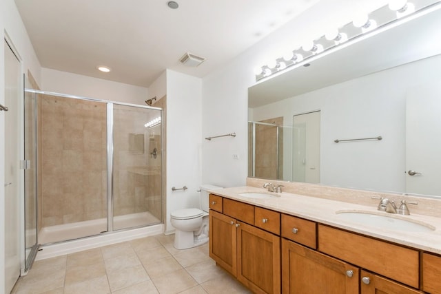 bathroom with tile patterned flooring, vanity, toilet, and walk in shower