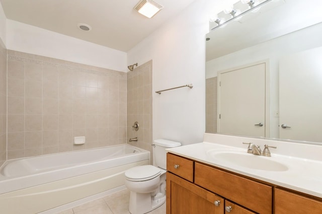 full bathroom with tile patterned flooring, tiled shower / bath, vanity, and toilet