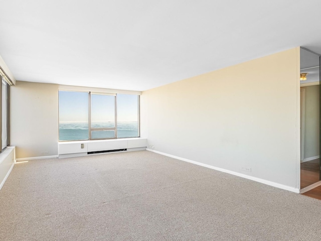 empty room with carpet and a water view