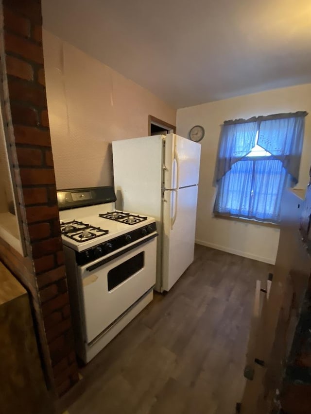 kitchen with white appliances and dark hardwood / wood-style floors