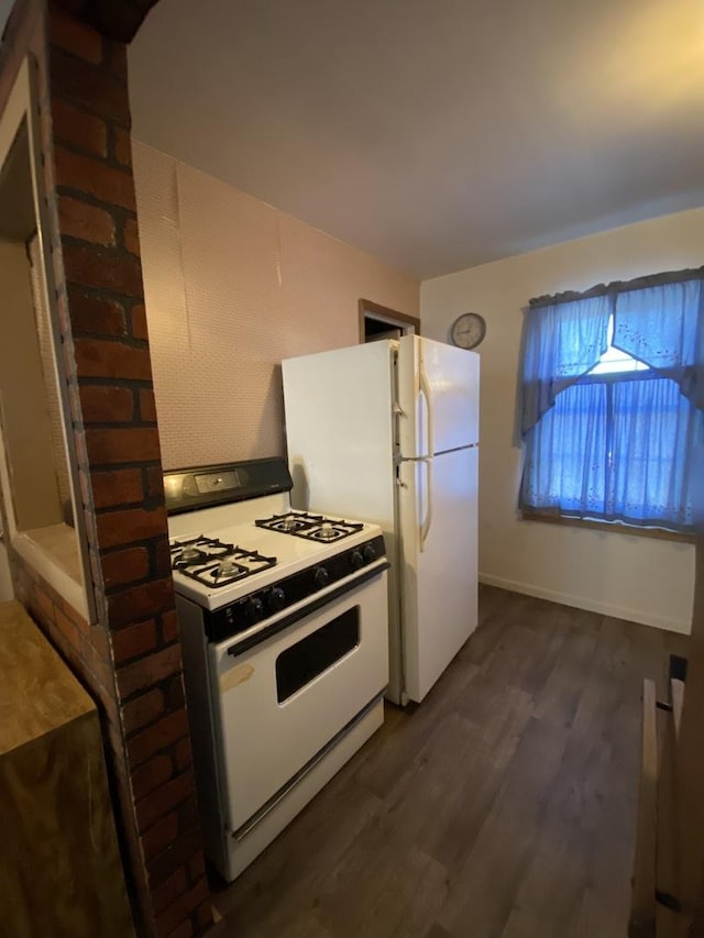 kitchen featuring white appliances and dark hardwood / wood-style flooring