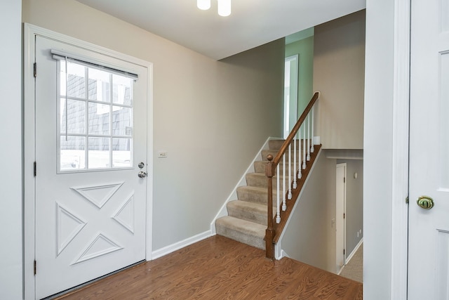 doorway to outside with stairway, baseboards, and wood finished floors