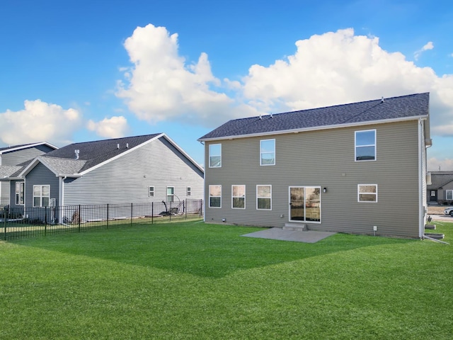 rear view of house with a lawn and a patio area