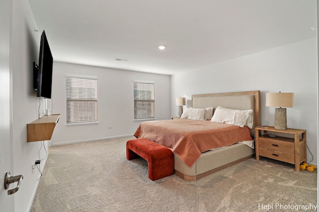 bedroom featuring light carpet