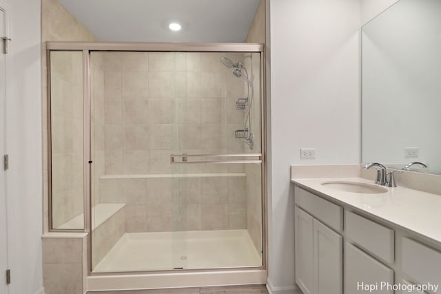 bathroom featuring vanity and a shower with shower door