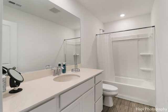 full bathroom featuring vanity, toilet, hardwood / wood-style floors, and shower / bath combo