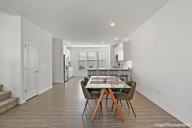 dining space with light hardwood / wood-style flooring