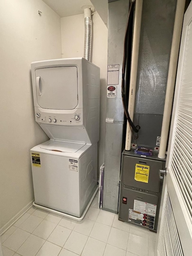 washroom featuring stacked washer / drying machine