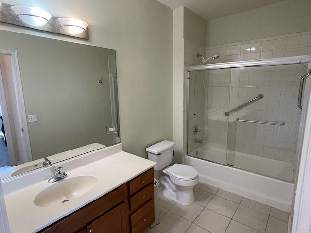 full bathroom with enclosed tub / shower combo, vanity, tile patterned floors, and toilet