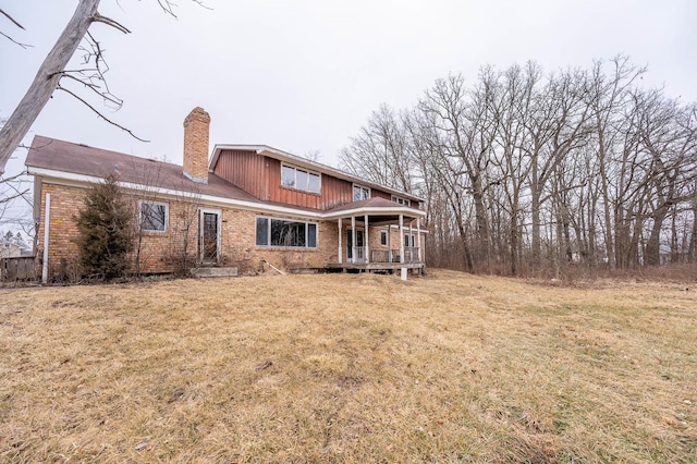 back of property featuring a lawn and a porch