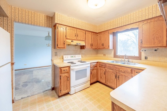 kitchen with white electric stove, sink, and decorative backsplash