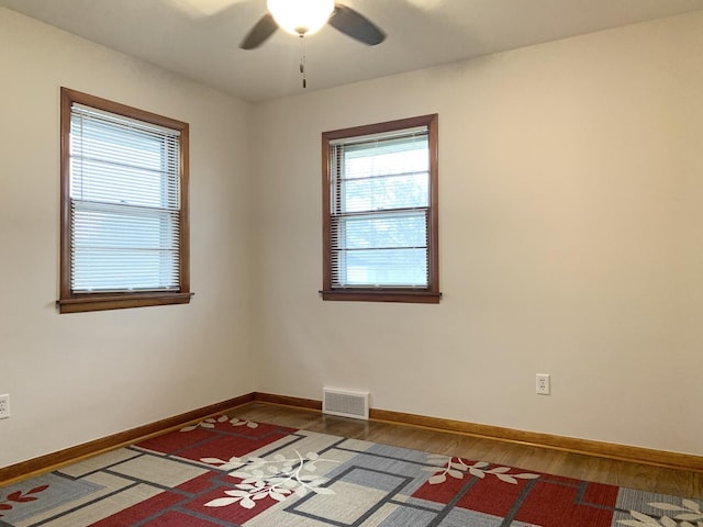 spare room featuring hardwood / wood-style floors and ceiling fan