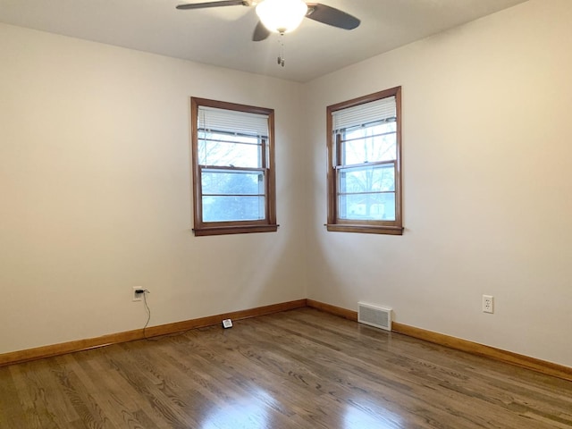 spare room with hardwood / wood-style floors and ceiling fan