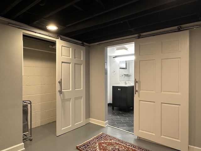 interior space featuring a barn door and sink