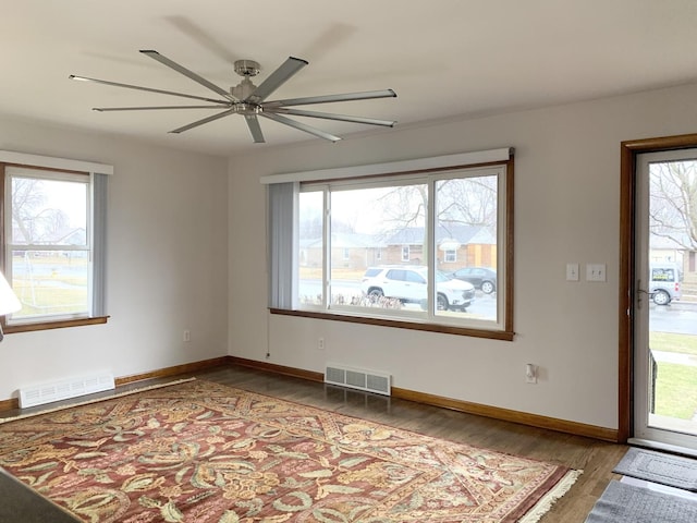 empty room featuring wood-type flooring and ceiling fan