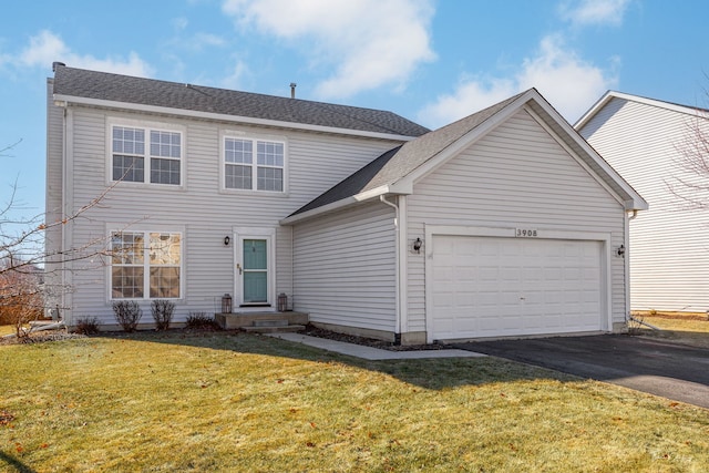 view of front of property with a garage and a front yard