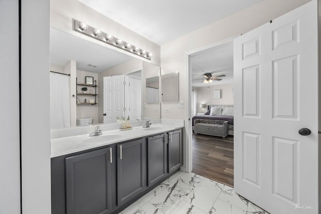 bathroom featuring ceiling fan, vanity, and toilet