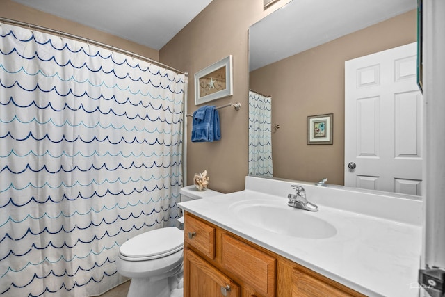 bathroom with walk in shower, vanity, and toilet