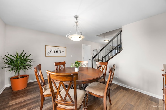 dining area with dark hardwood / wood-style flooring