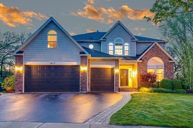 view of front facade featuring a garage and a yard