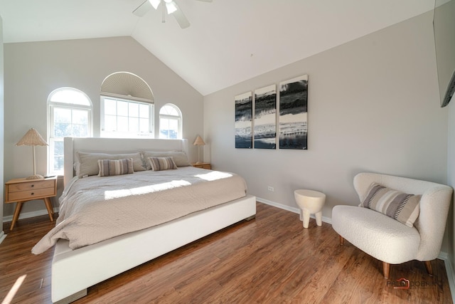 bedroom featuring hardwood / wood-style floors, high vaulted ceiling, and ceiling fan