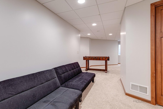 carpeted living room with a paneled ceiling