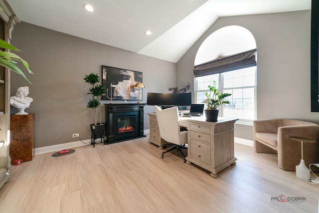 office space with lofted ceiling and light wood-type flooring