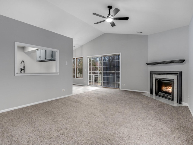 unfurnished living room with lofted ceiling, a fireplace, light colored carpet, and ceiling fan