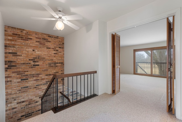 hall with brick wall and carpet floors