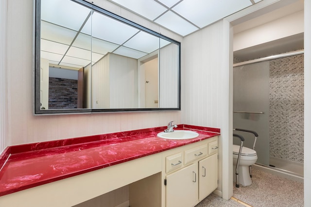 bathroom with vanity, toilet, and a shower with door