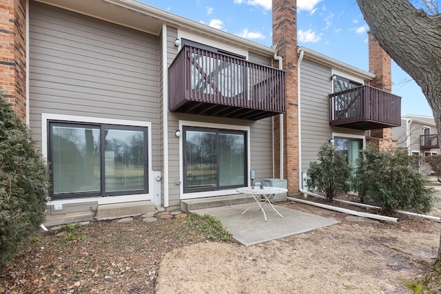 back of property with a patio and a balcony