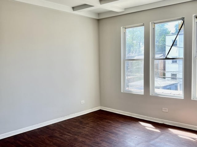 unfurnished room with beamed ceiling, coffered ceiling, and dark hardwood / wood-style flooring