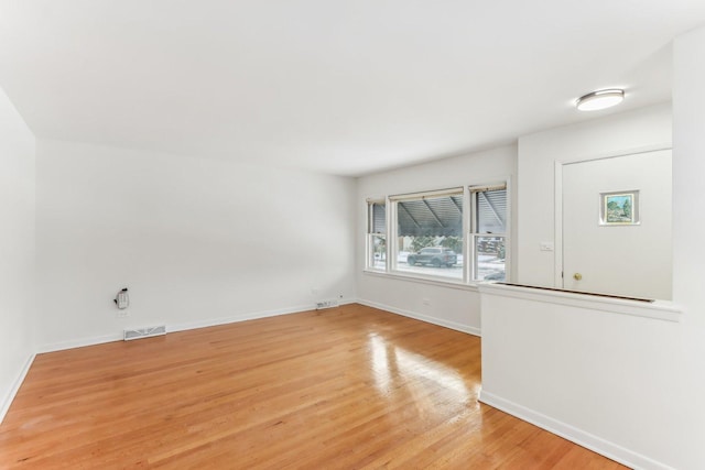 unfurnished room with light wood-type flooring