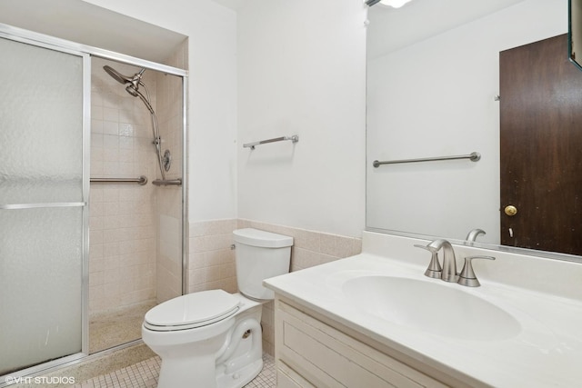 bathroom featuring tile walls, vanity, walk in shower, toilet, and tile patterned floors