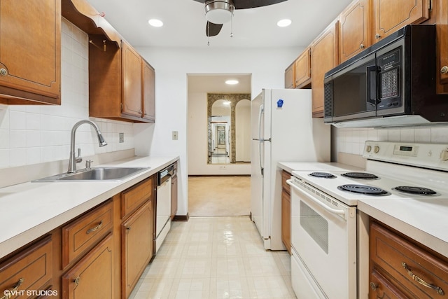 kitchen featuring ceiling fan, white appliances, sink, and tasteful backsplash