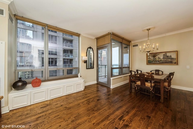 dining area featuring ornamental molding, dark hardwood / wood-style flooring, and a chandelier