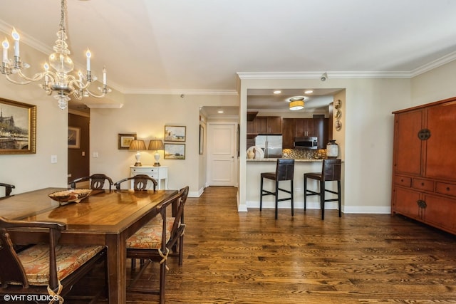 dining area featuring dark wood-type flooring, ornamental molding, and a notable chandelier