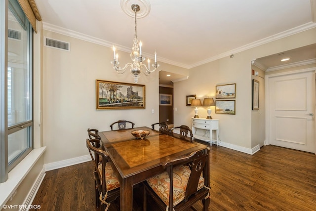 dining room featuring ornamental molding, dark hardwood / wood-style floors, and a chandelier